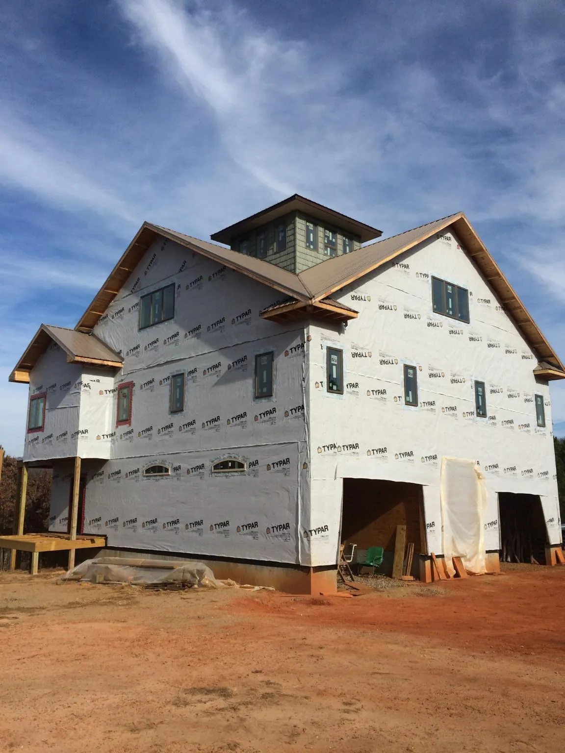 New two story house under construction with a cupola and gabled roofs in Saint Paul Park